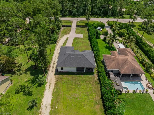 Aerial view of property and surrounding area with a pool