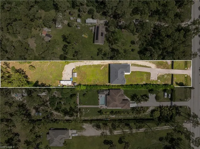 Aerial view of property and surrounding area featuring property boundaries highlighted