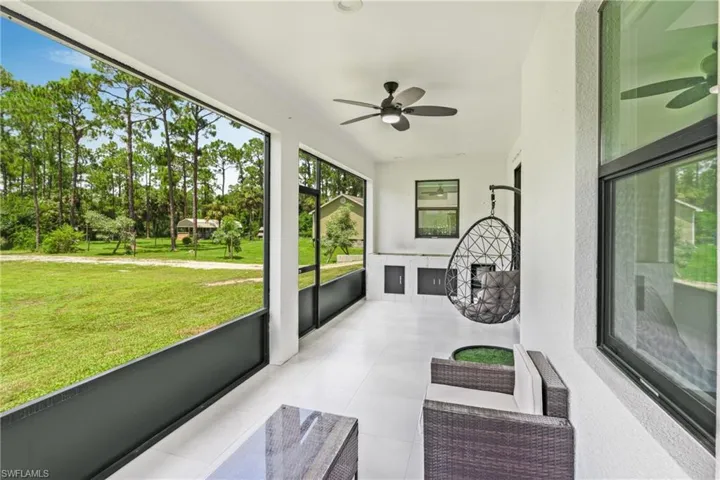 Sunroom / solarium featuring ceiling fan