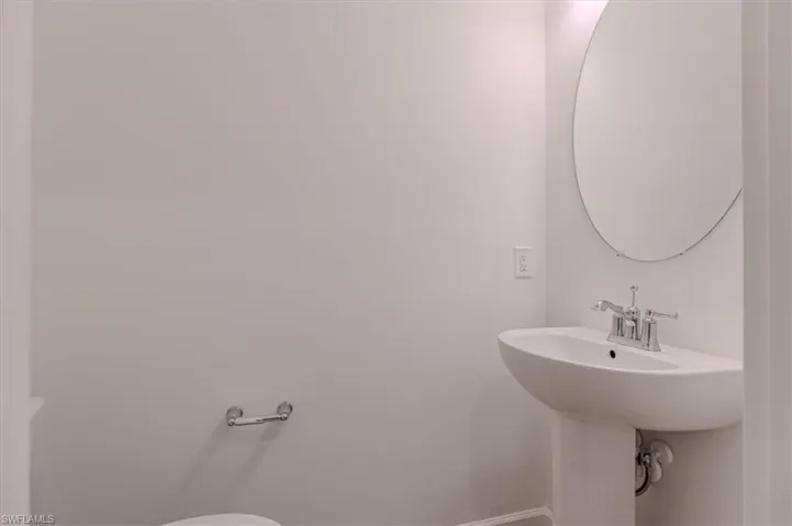Bathroom featuring toilet and baseboards