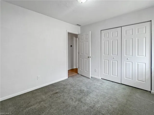 Unfurnished bedroom with carpet floors and a closet