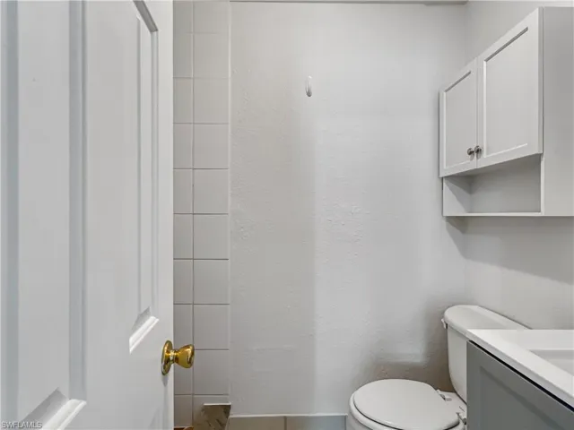 Bathroom featuring vanity and a textured wall