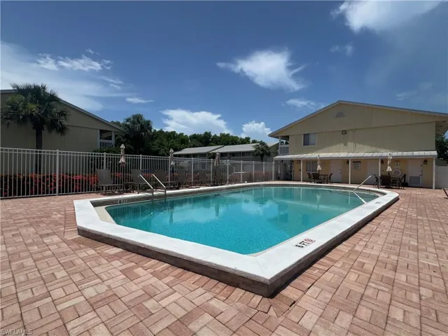 Community pool with a patio
