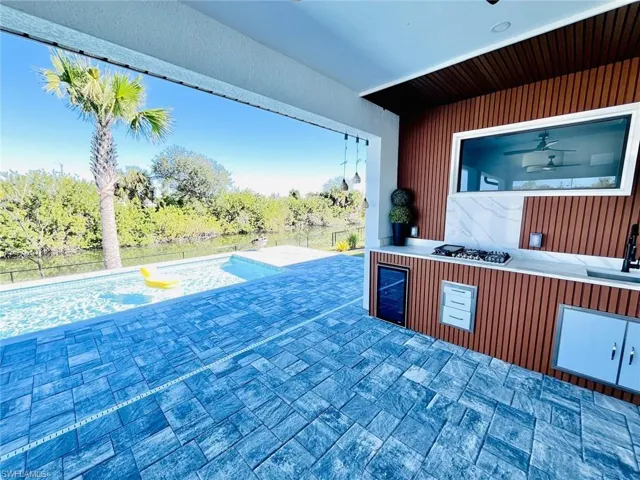 View of patio / terrace with a swimming pool and wine cooler