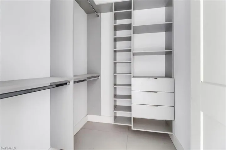 Spacious closet featuring light tile patterned flooring