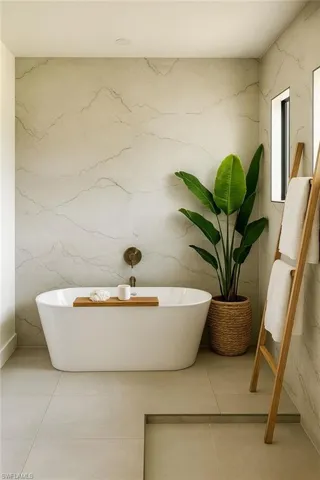 Full bathroom with tile patterned floors and a freestanding tub