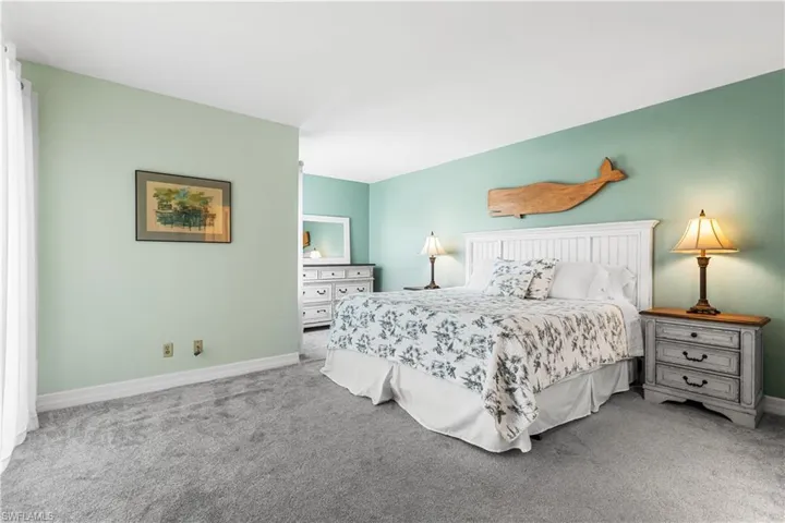 Bedroom with light colored carpet
