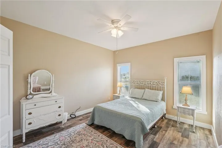 Bedroom with wood finished floors and ceiling fan