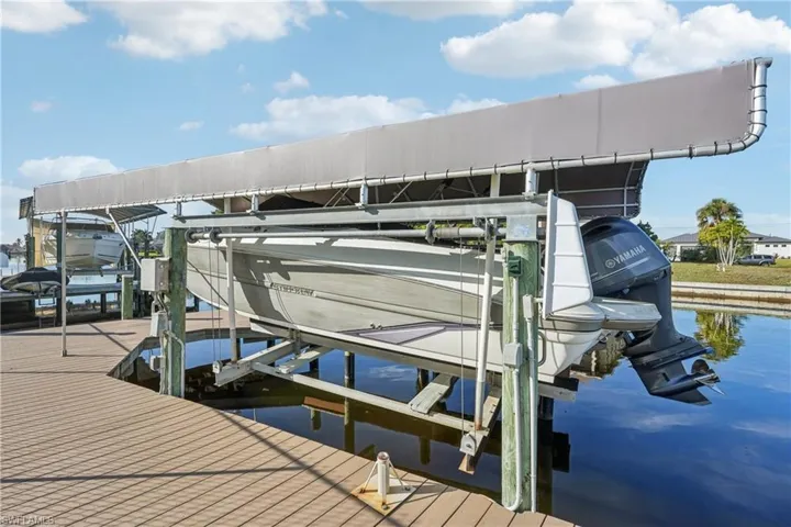 Dock with boat lift and a water view