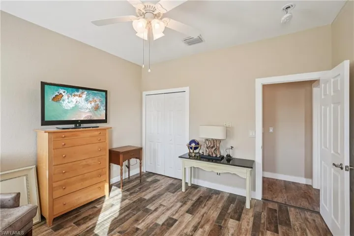 Office space featuring dark wood-style floors and ceiling fan