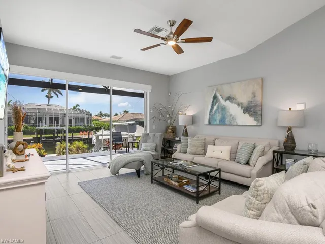 Living area featuring ceiling fan and a residential view