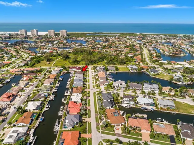 Aerial overview of property's location with a large body of water and nearby suburban area