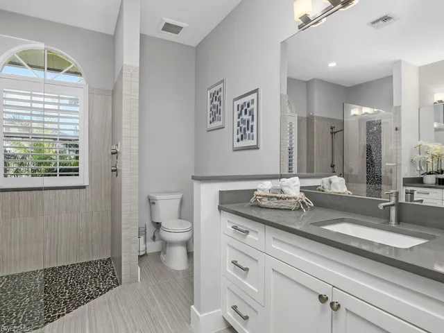 Bathroom featuring vanity and a walk in shower