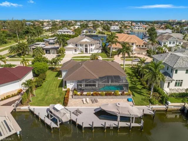 Aerial view of residential area featuring a nearby body of water