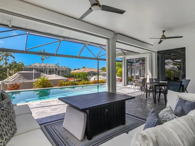 View of patio featuring ceiling fan, outdoor lounge area, outdoor dining space, an outdoor pool, and a lanai