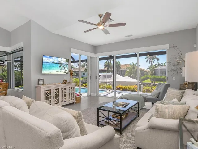 Living room featuring ceiling fan and wood finished floors