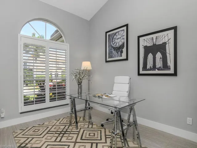 Office space featuring vaulted ceiling and baseboards
