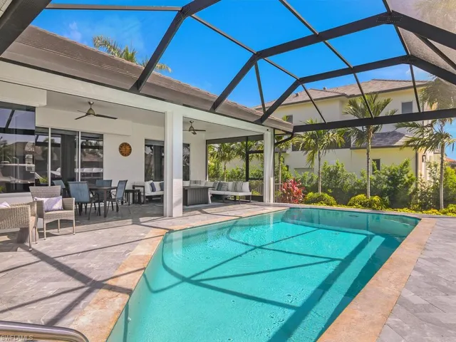 Outdoor pool featuring outdoor lounge area, ceiling fan, a patio area, and glass enclosure