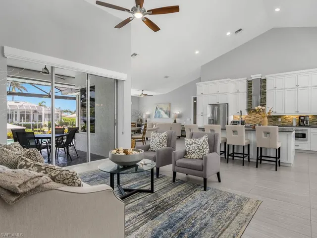 Living room featuring ceiling fan, high vaulted ceiling, and recessed lighting
