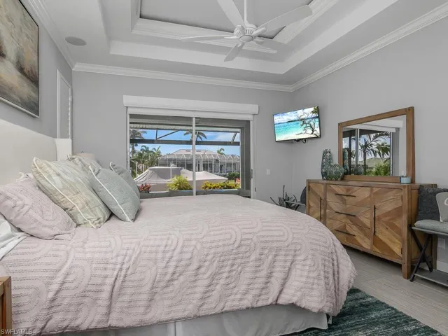 Bedroom with access to exterior, crown molding, and a ceiling fan