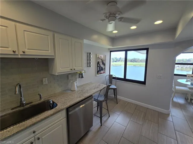 Kitchen with White Cabinets and Fresh Counters and Backsplash!