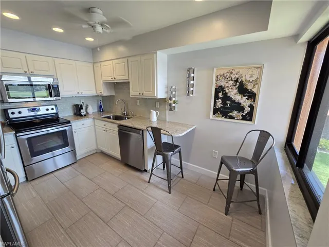 Kitchen Featuring Stainless Steel Appliances, Ceiling Fan, Newer Porcelain Tile Flooring!