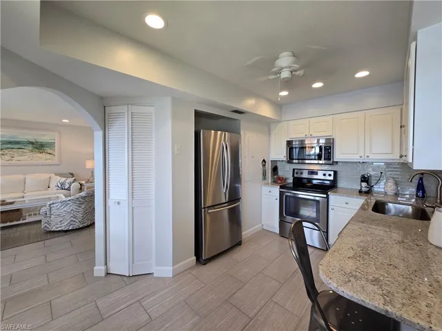 Kitchen Featuring Updated Counter Tops and Backsplash, Fresh Paint, and Recessed Lighting!
