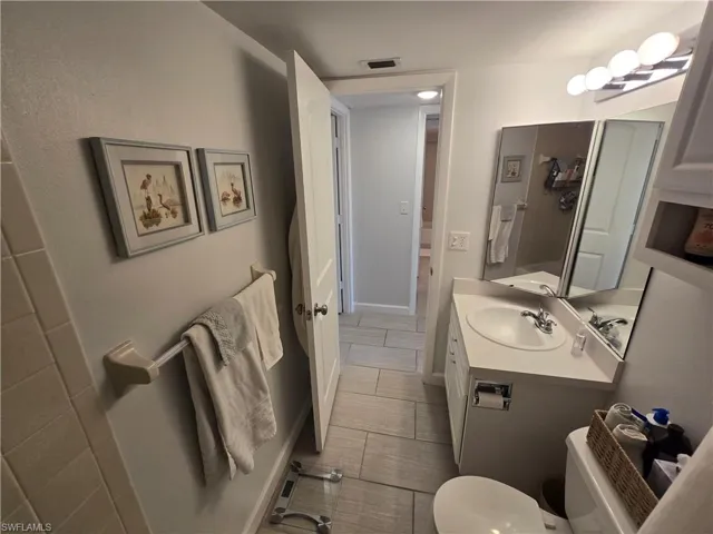 Second Full Bathroom Featuring Shower/Tub Combo with Curtain, Wall Cabinet, Exhaust Fan and Vanity!