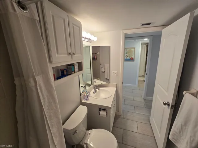 Private Primary Bathroom with Shower/Bathtub Combination with Curtain, Light Bar and Vanity!