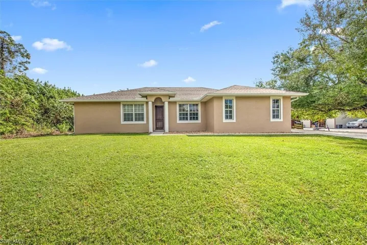 Ranch-style home featuring a front yard