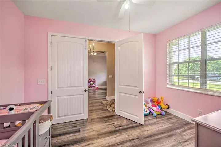 Bedroom with ceiling fan and hardwood / wood-style flooring