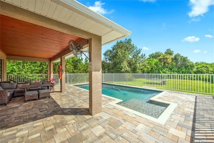 View of pool with a patio and an outdoor hangout area