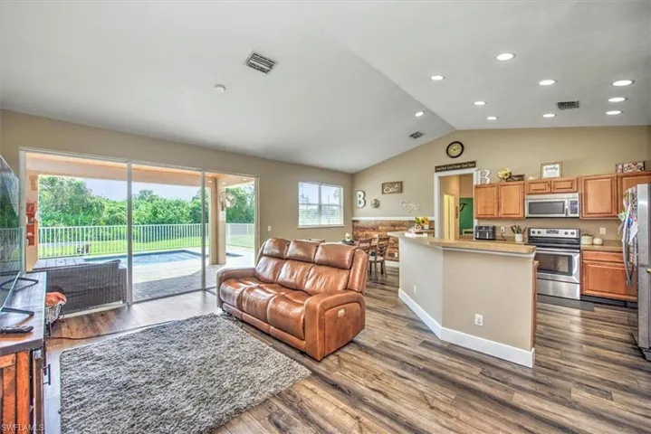 Living room with hardwood / wood-style floors and a healthy amount of sunlight