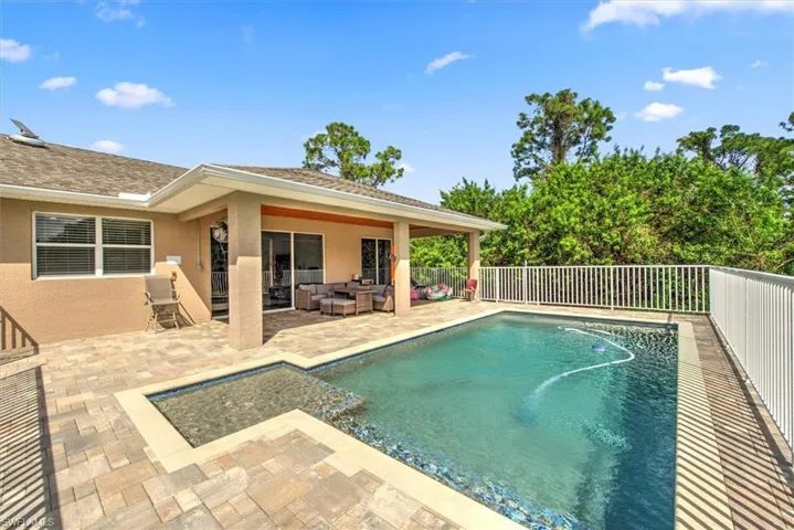 View of swimming pool with an outdoor living space and a patio