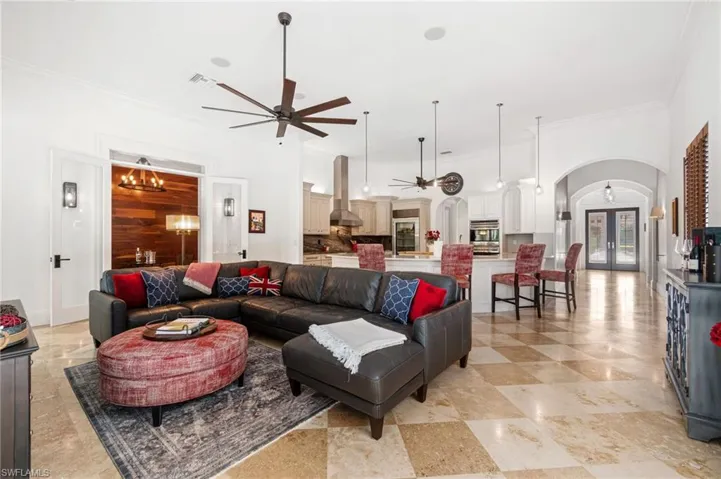Great room, kitchen, wine room/flex space overlooking pool area