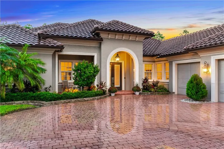 Contemporary home featuring a custom brick paver driveway, and an oversized 3 car garage