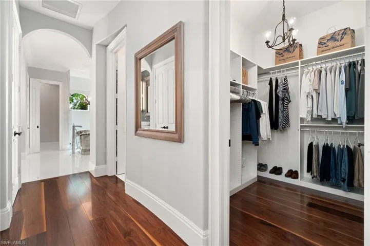 Walk in closet leading to Primary ensuite from Primary bedroom, exclusive laundry room to the right past walk in closet