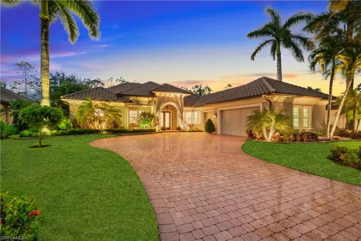Contemporary home featuring a beautifully landscaped lawn and an oversized 3 car garage