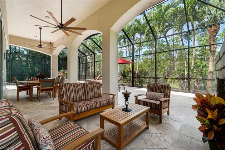 Lanai sitting area in front of outdoor fireplace, dining area