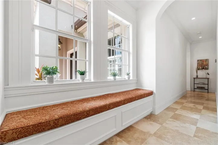 Garage entry into home with custom built in seating, detailed millwork