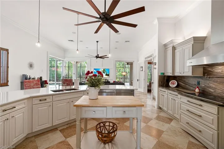 Kitchen overlooking great room featuring pool, lanai, preserve view