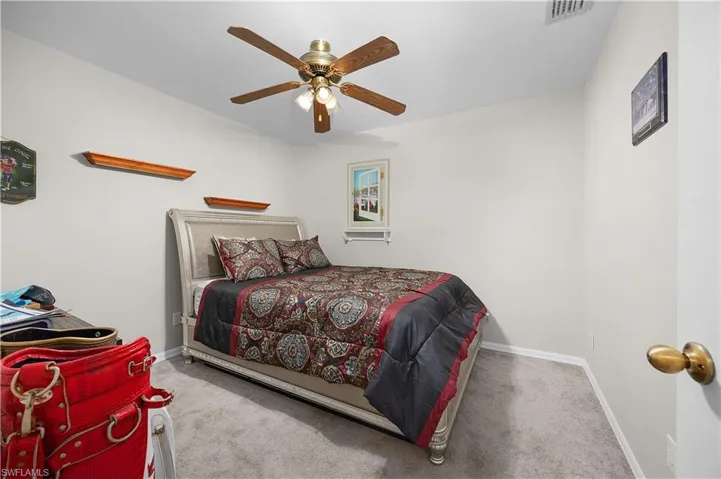 Unfurnished sunroom with ceiling fan