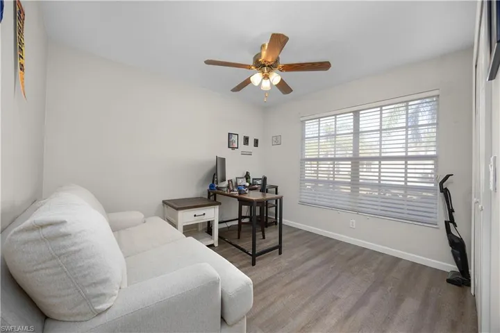 Home office with wood finished floors and ceiling fan