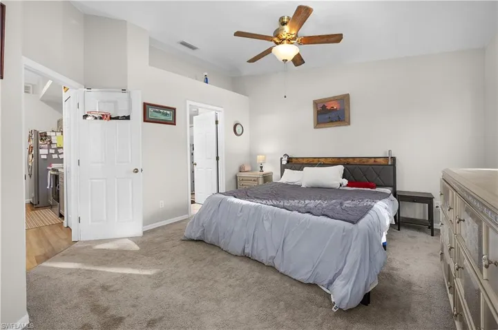 Bedroom featuring lofted ceiling, carpet floors, and a ceiling fan