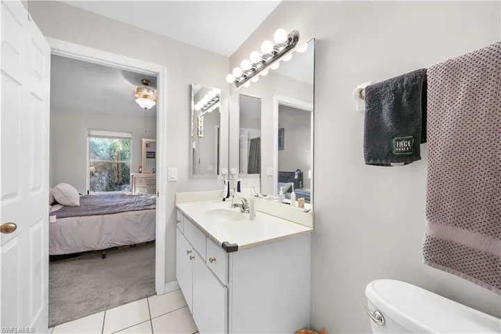 Full bathroom with vanity, wood finished floors, and shower / bath combo with shower curtain