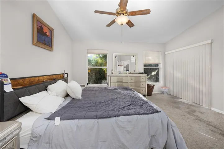 Bathroom featuring a spacious closet, vanity, curtained shower, and light tile patterned flooring
