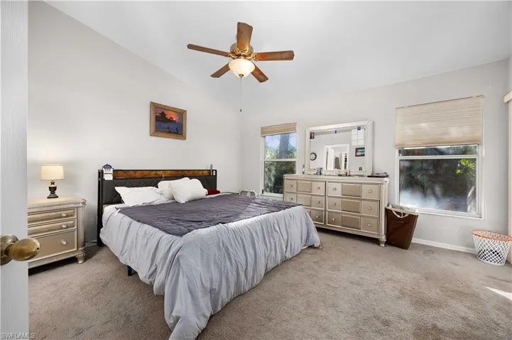 Bathroom with ensuite bath, vanity, light carpet, and light tile patterned flooring