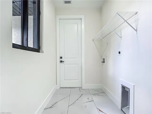 Washroom featuring light marble finish flooring, washer hookup, and electric dryer hookup