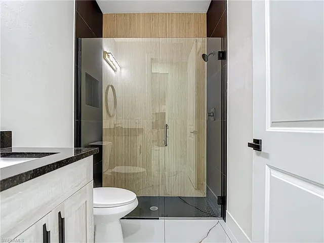 Full bath with vanity and a shower stall
