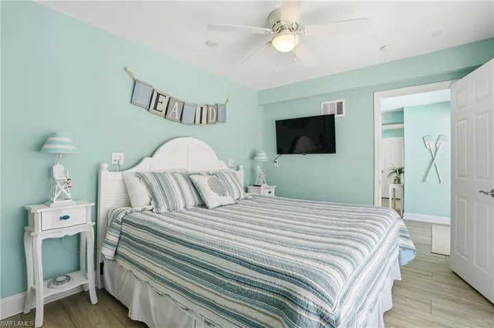 Bedroom with a ceiling fan and light wood-type flooring
